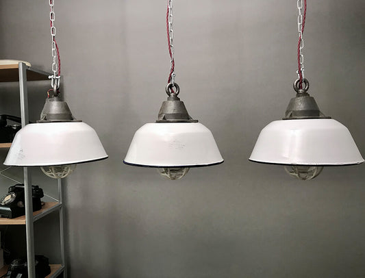 3 Vintage Industrial Enamel Lights. 20th century industrial light cases sourced from Budapest.