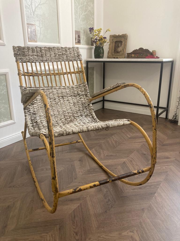 With its metal frame and wicker/straw seat and back, this Vintage Metal Framed Rocking Chair is sure to provide comfortable seating for years to come. The wooden arms and mustard yellow paint offer a classic aesthetic that will bring a unique patina to your home. Enjoy the nostalgic feeling of a good old-fashioned rocking chair, but with the added resilience of metal.