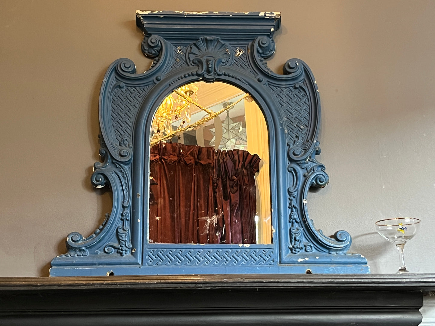 Two Victorian Cast Iron Over Mantle Mirrors. Unique -' one of a kind'  pieces that  would suit a mix of interiors.   These  decorative Over Mantles have been cast from iron with decorative motifs throughout and with the original mirrors in situ.   The blue overmantles' mirror  has been  repaired  using the Japanese Kintsugi method,  which roughly translates as 'joining with gold'